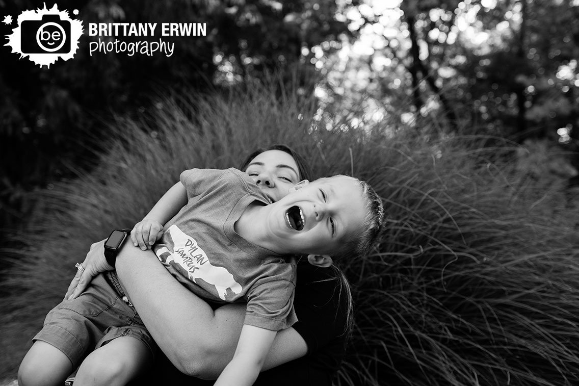outdoor-summer-portrait-photographer-mother-holding-son-laughing-by-tall-grass.jpg