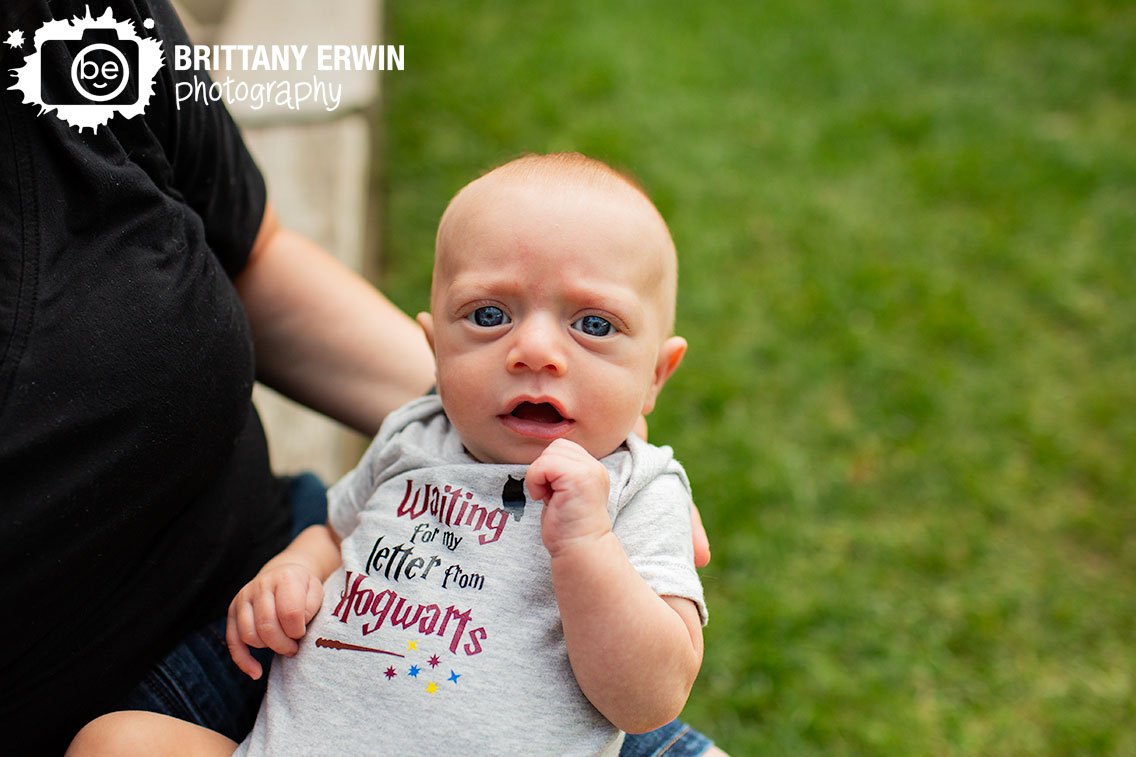 Indianapolis-portrait-photographer-baby-boy-held-by-mother-with-hogwarts-letter-outfit.jpg