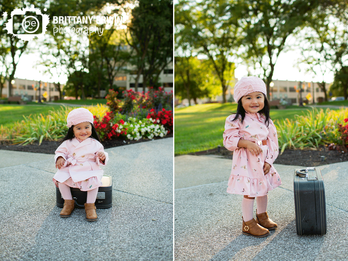 Indianapolis-downtown-birthday-portrait-photographer-girl-with-antique-suitcase-fall-pink-hat-with-matching-dress.gif