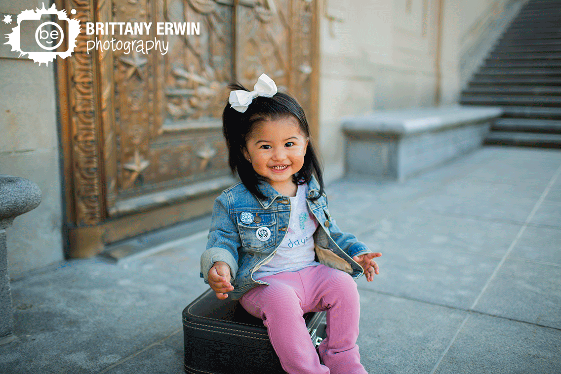 Indianapolis-downtown-portrait-photographer-girl-sitting-on-suitcase-first-birthday-portrait.gif