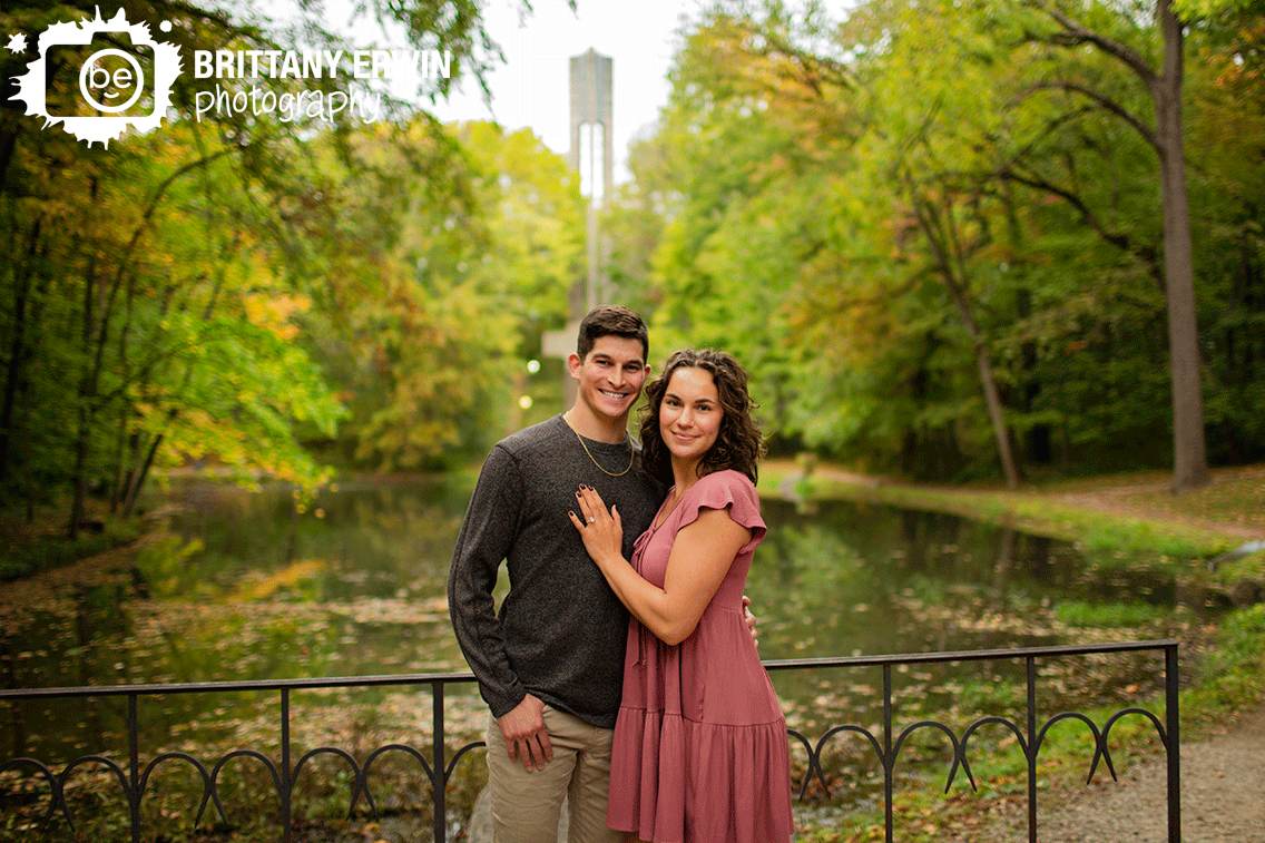 Holcomb-Garden-Engagement-portrait-couple-by-pond-with-bell-tower.gif