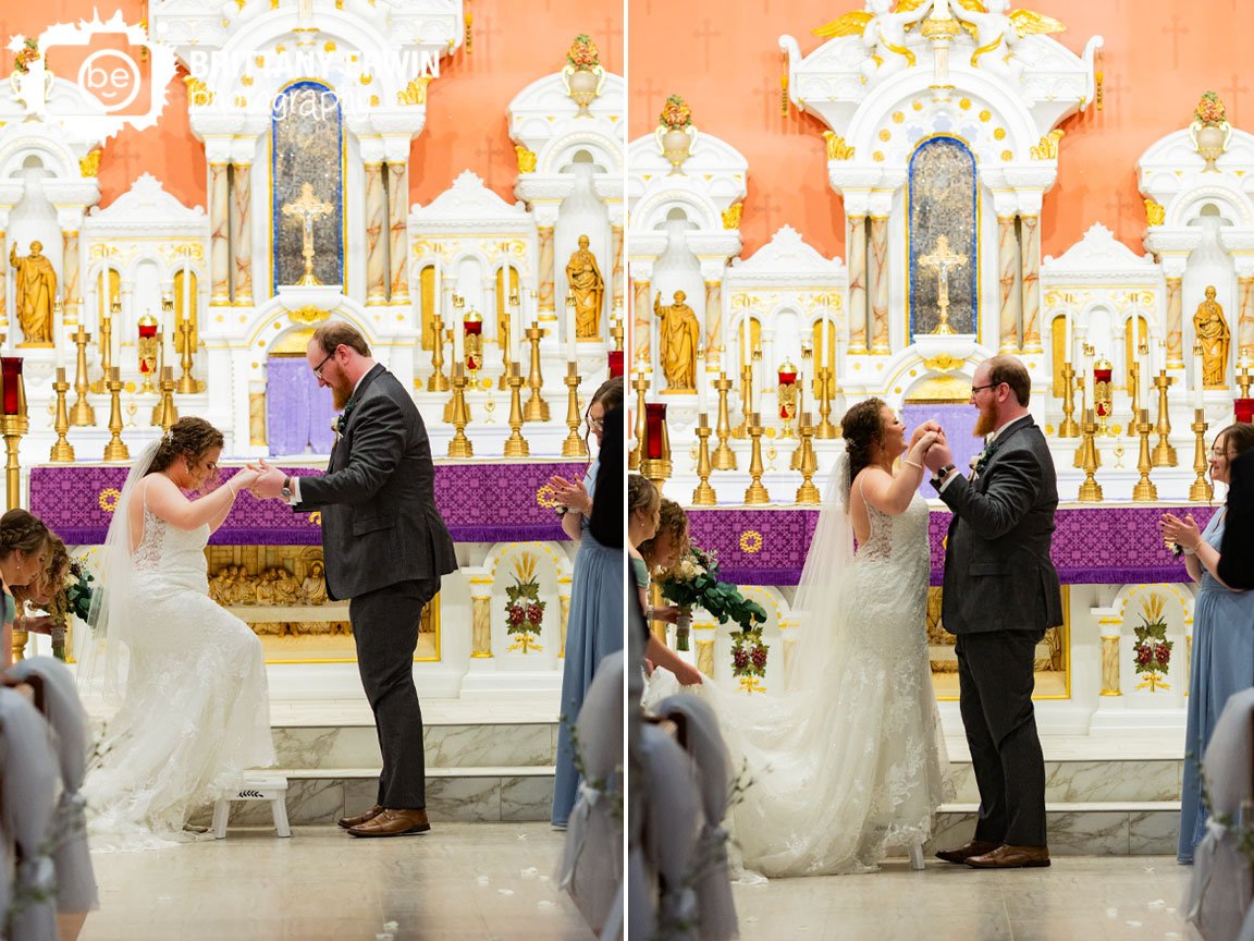 bride-stepping-onto-stool-for-first-kiss.jpg