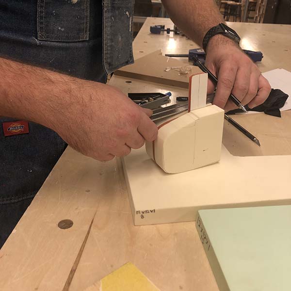 Bart designed a pyro mallot that creates fire using the fire piston mechanism. His final model is made of dense foam and acrylic using tools in the woodshop.
