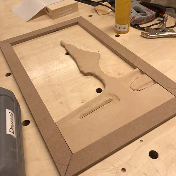 Once the finished product is put together, he will place it against natural light and the form inside the frame will be visible. Today he worked on mitering the frame corners, which he is still working through.