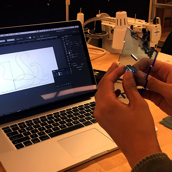 Lili is making a "box in the shape of an octopus" using lovely, translucent acrylic. Here, you can see her testing some options for joining the “arms” to the box.
