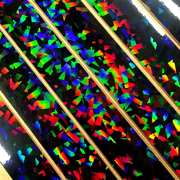 Petros Lales of MFA Photo, Video, and Related Media explores methods for cutting holographic tape into specific shapes as part of a personal project to make a board game.