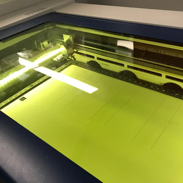 Once your material is etched hide the etching layer and make the cut layer visible again. Print the cut layer with the proper settings.