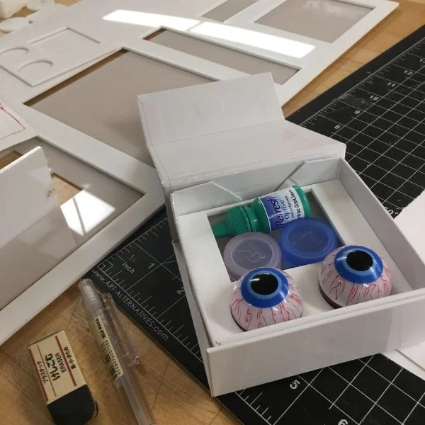 Her first prototype is of a package for new contacts users which includes a set of surrogate eyeballs to practice putting on and taking off contacts before they would have to try on their own eyes.