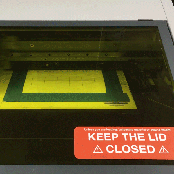 First-year MFA Design student Qingping Wang is using the Visible Futures Lab's UV Printer to print on the delicate surface of a plastic shopping bag.