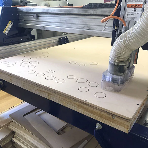 Our very own student worker Owen Keogh is in the VFL today to use the CNC router. He's currently helping an artist produce a series of picture frames that are in the shape of space program patches. MDF