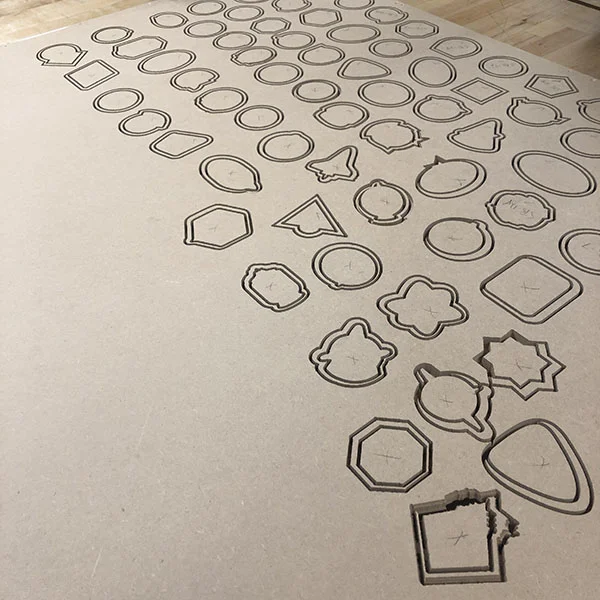 He's doing this by first creating a vector file and then using the Shopbot CNC router to cut the shapes.