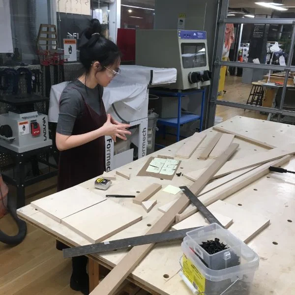She is using the router, band saw and table saw as well as our handy corner clamps to turn some of our tasty scrap into a solid piece for her experience.