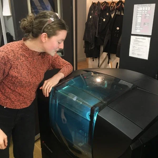VFL Staffer Elizabeth Meiklejohn is putting the Objet printer through its paces today. She is creating small intricate pieces which will act as end caps for thread holders on a loom she is building.