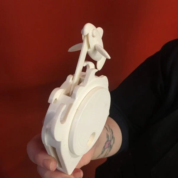 VFL staffer Oya Kosebay was flexing her 3D printing muscles with this fishy automata. She created a multi-body STL file and adjusted the tolerances to make the part move after dissolving the support material.