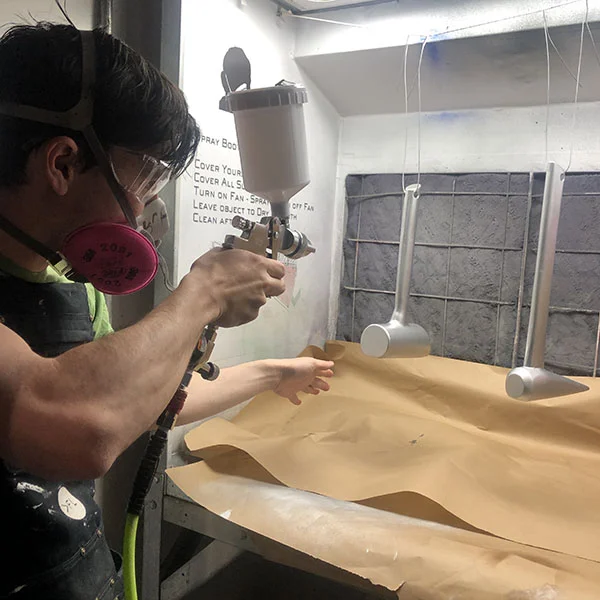 John Boran Jr. of MFA Products of Design came in today to use the department's brand new spray gun. He's in the spray booth to do some bluing coats on tools he designed for his thesis on Mars colonization.