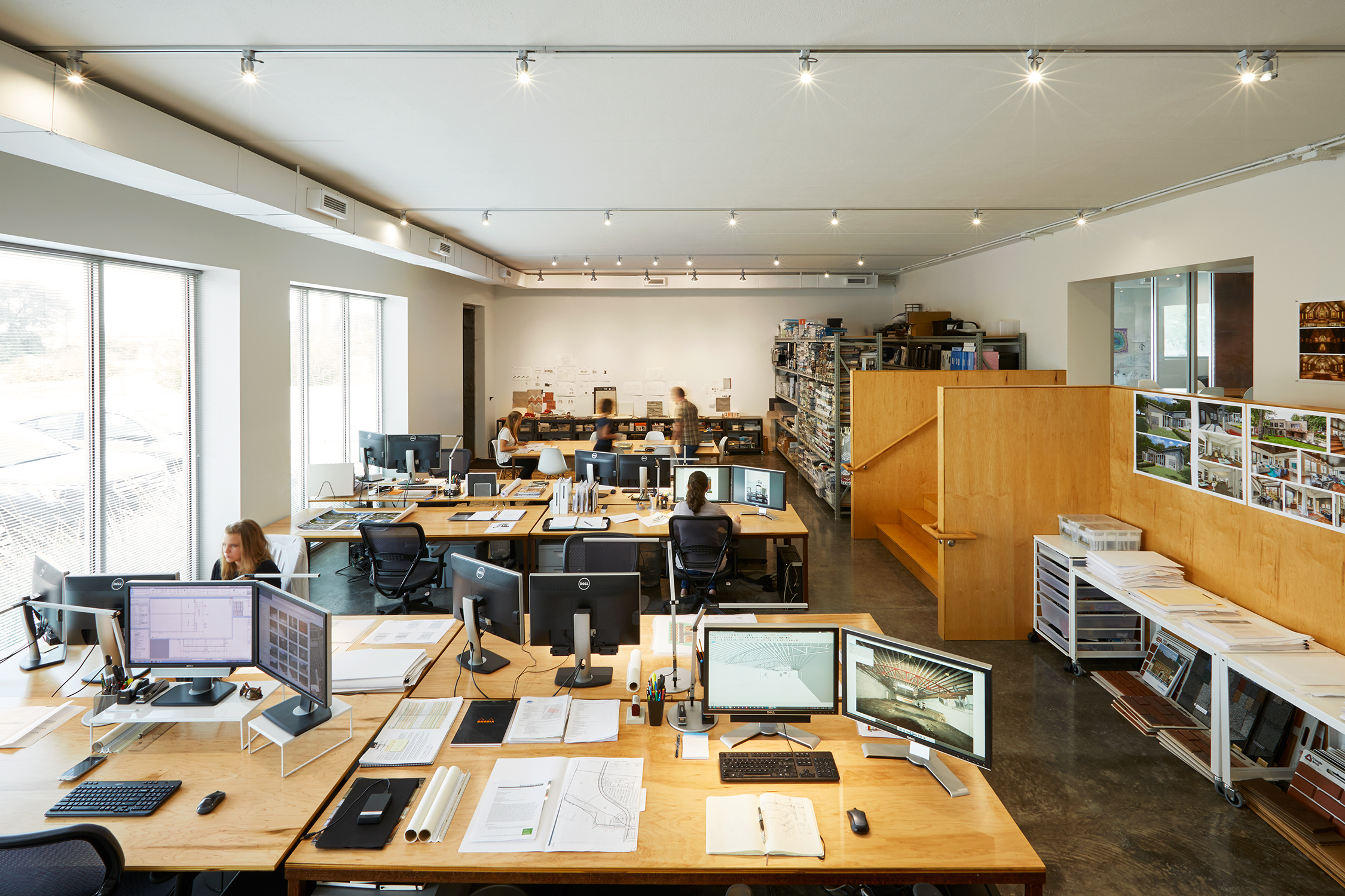 The existing 12' Ceiling Car Repair Garage was transformed into the Design Studio Space. The garage doors were replaced with large windows.