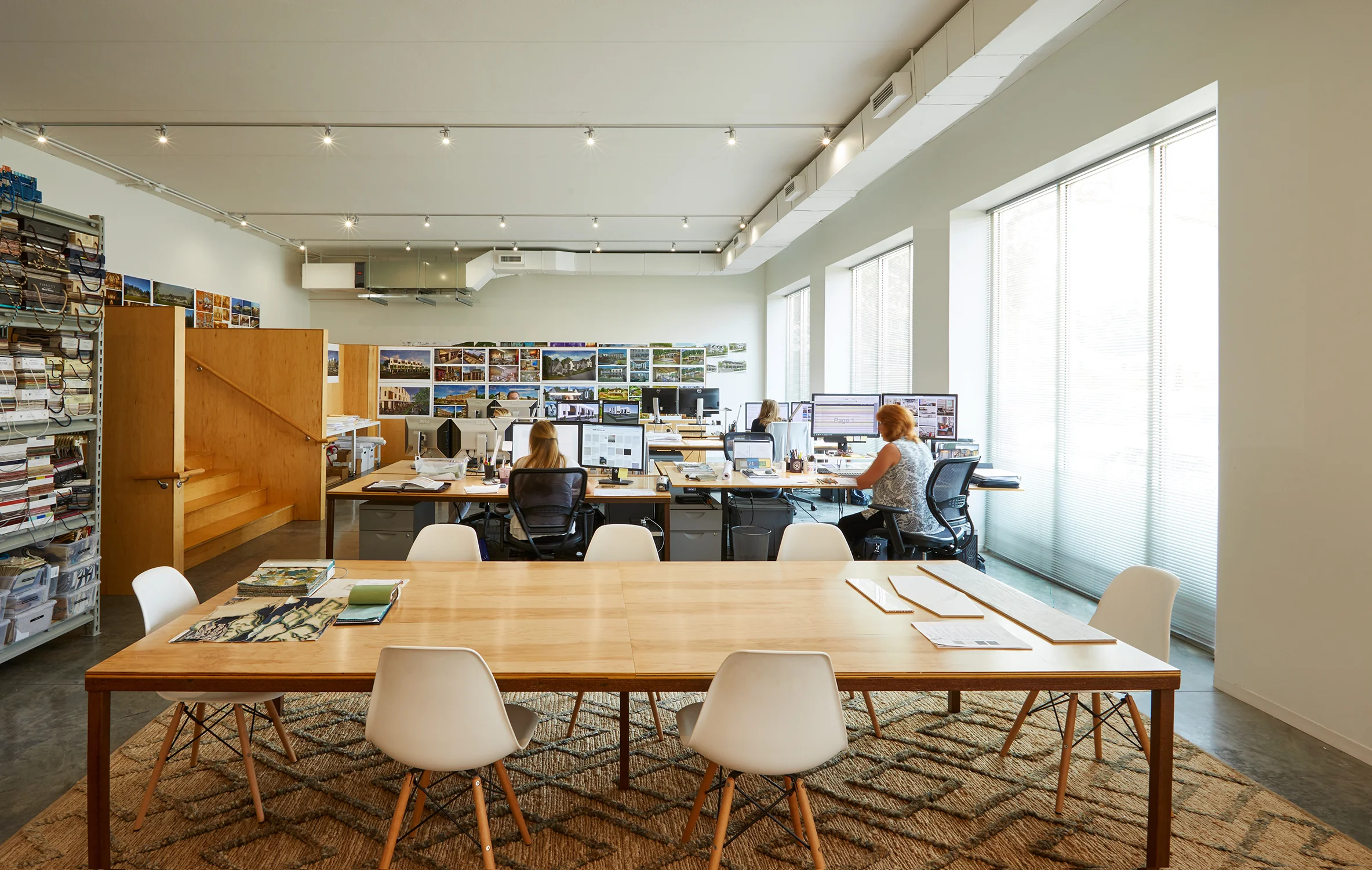 The existing 12' Ceiling Car Repair Garage was transformed into the Design Studio Space. The garage doors were replaced with large windows.