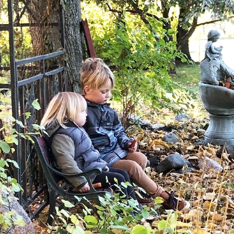 sister and brother sitting garden portage la prairie manitoba