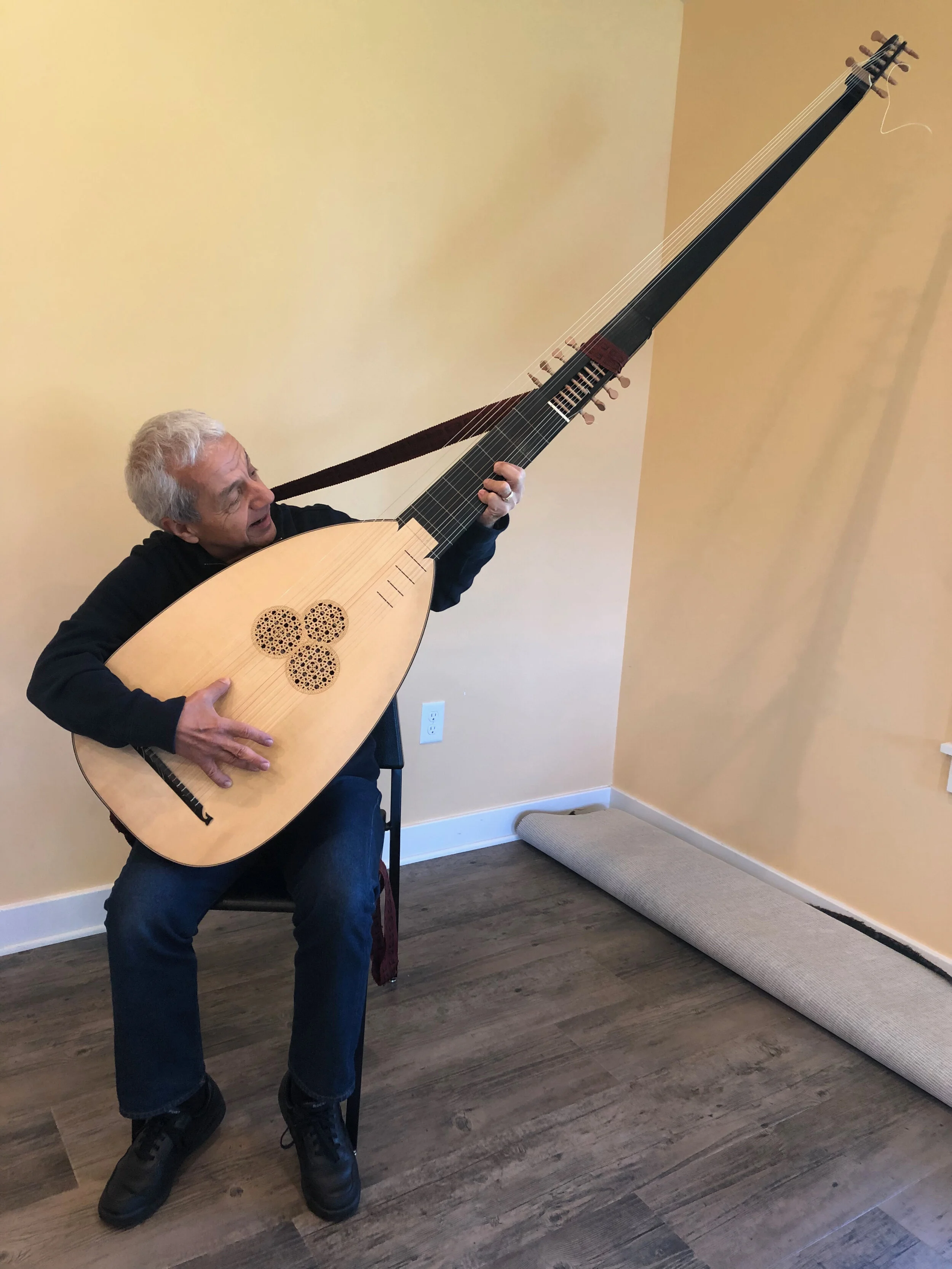 Tony with a six-foot-plus long baroque theorbo, a type of lute.
