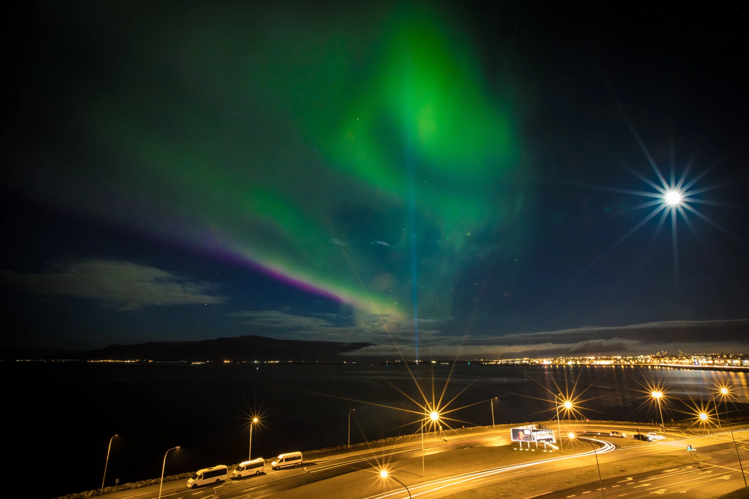 This shot was taken of the Northern Lights in Iceland. I used a 30 second shutter speed. You will notice at the bottom of the photo the car lights are continuous trails. Also, the Northern Lights are more of a blur of color rather than distinct light bands that you might see on other Northern Lights shots. Even with all the city lights and a full moon you can still see some stars at this setting. Canon 5D Mark IV, 18mm | f/22, 30 seconds, ISO 100