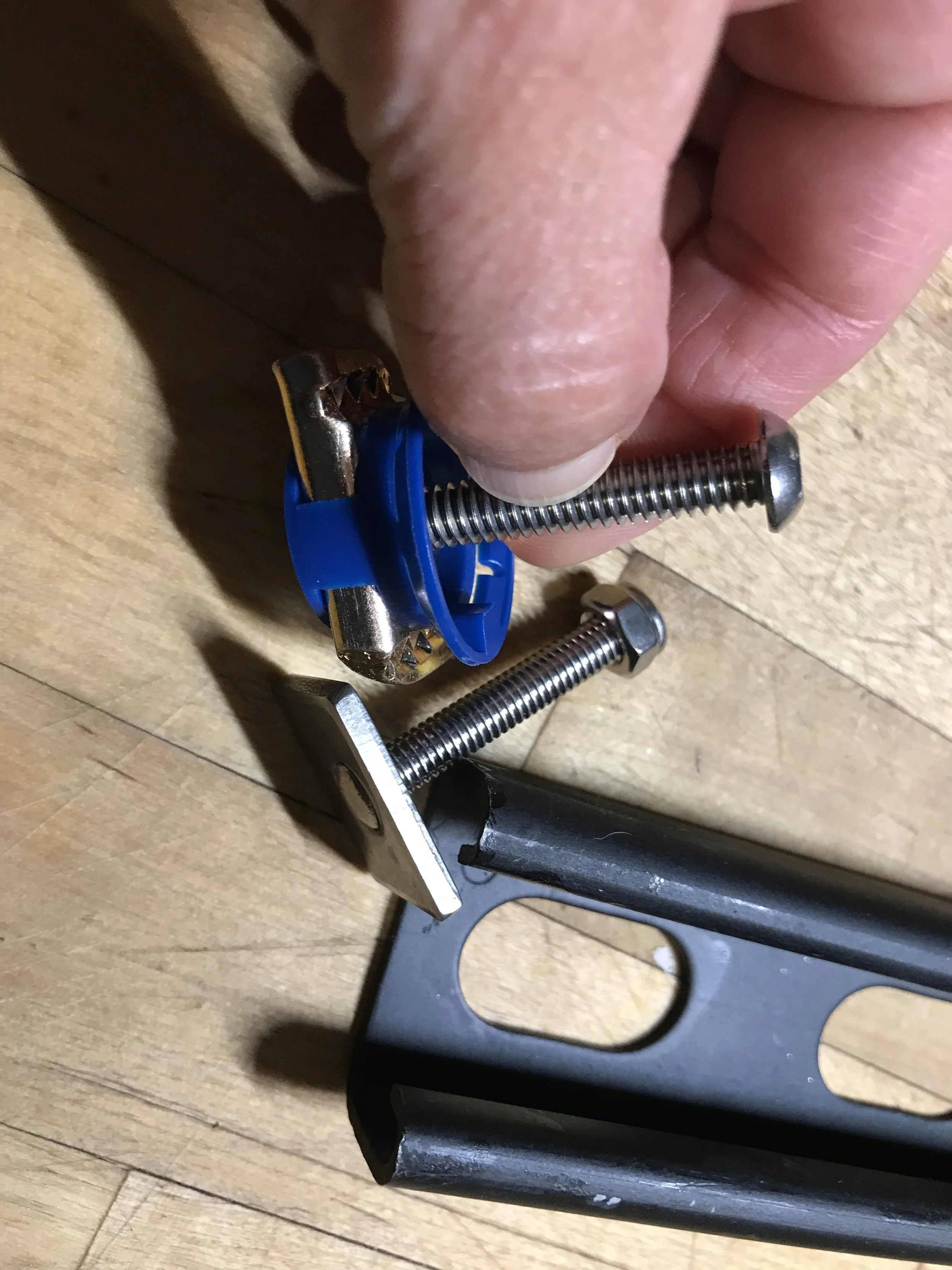 Unistrut nut and stainless bolt versus included hardware for Lockrack. Nut and bolt cost about $1.50 each. You will need 4.