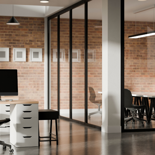 Modern office space with glass partitions, brick walls, and simple furniture.