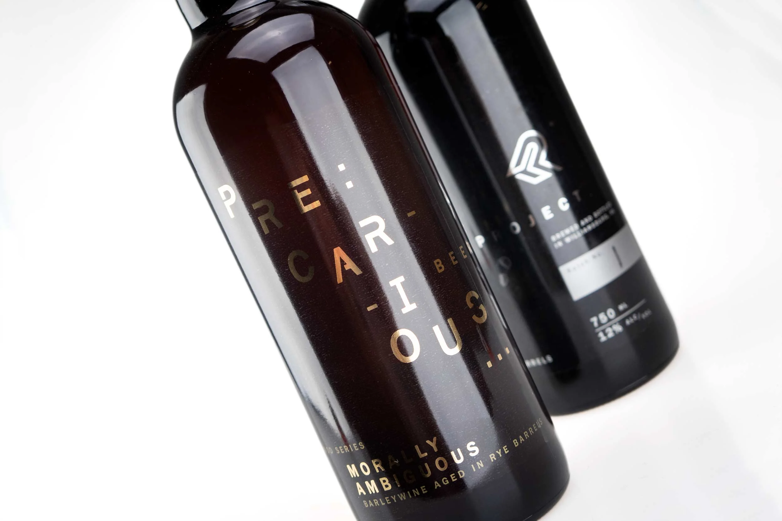 Detail view of transparent bottle labels for Precarious Beer Project Morally Ambiguous and Ethically Flexible
