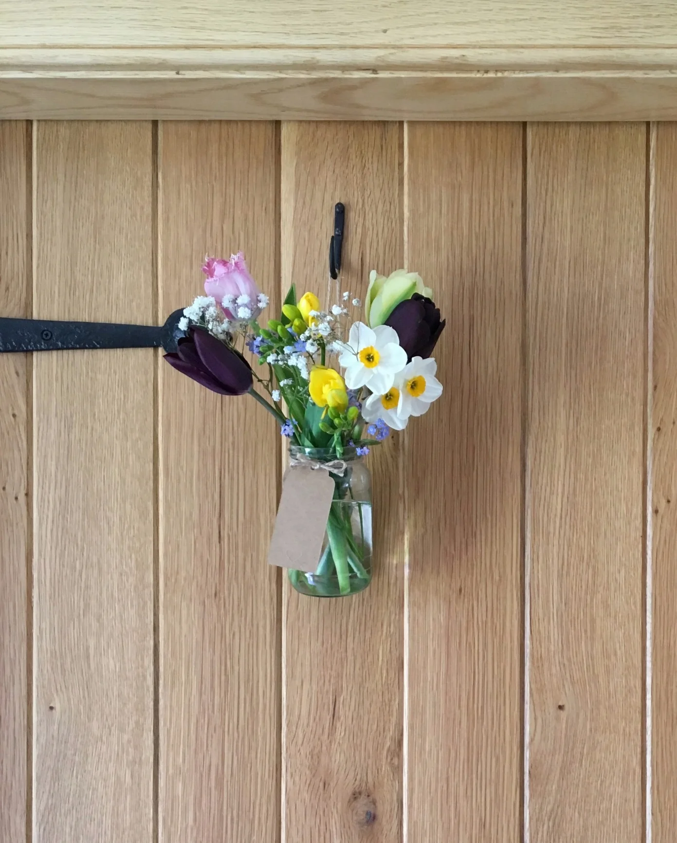 Jam jars of spring pickings hanging from the doors.