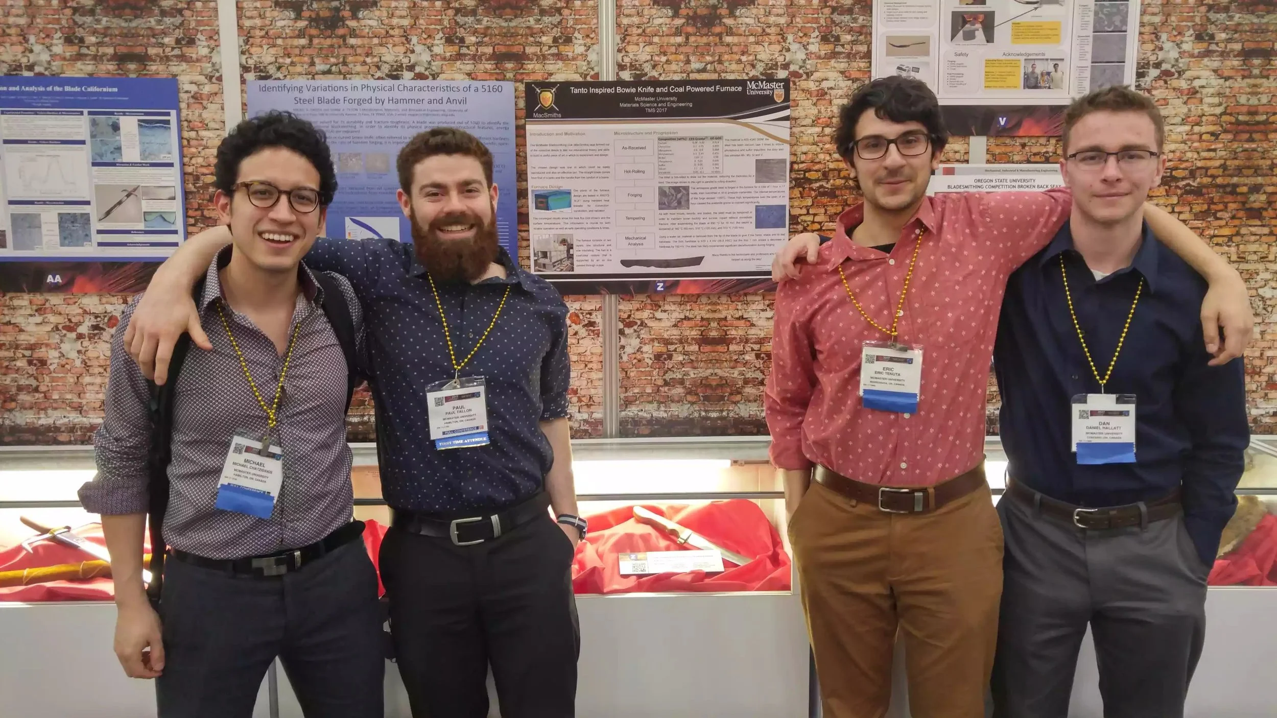(Left to Right) Michael Chatzidakis, Paul Tallon, Eric Tenuta, Dan Hallat at TMS2017 in front of our sword and poster in San Diego