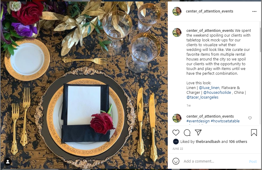 Instagram post showing an overhead place setting on black and gold damask linen with a gold-rimmed charger, black napkin, tucked menu card and a single red rose