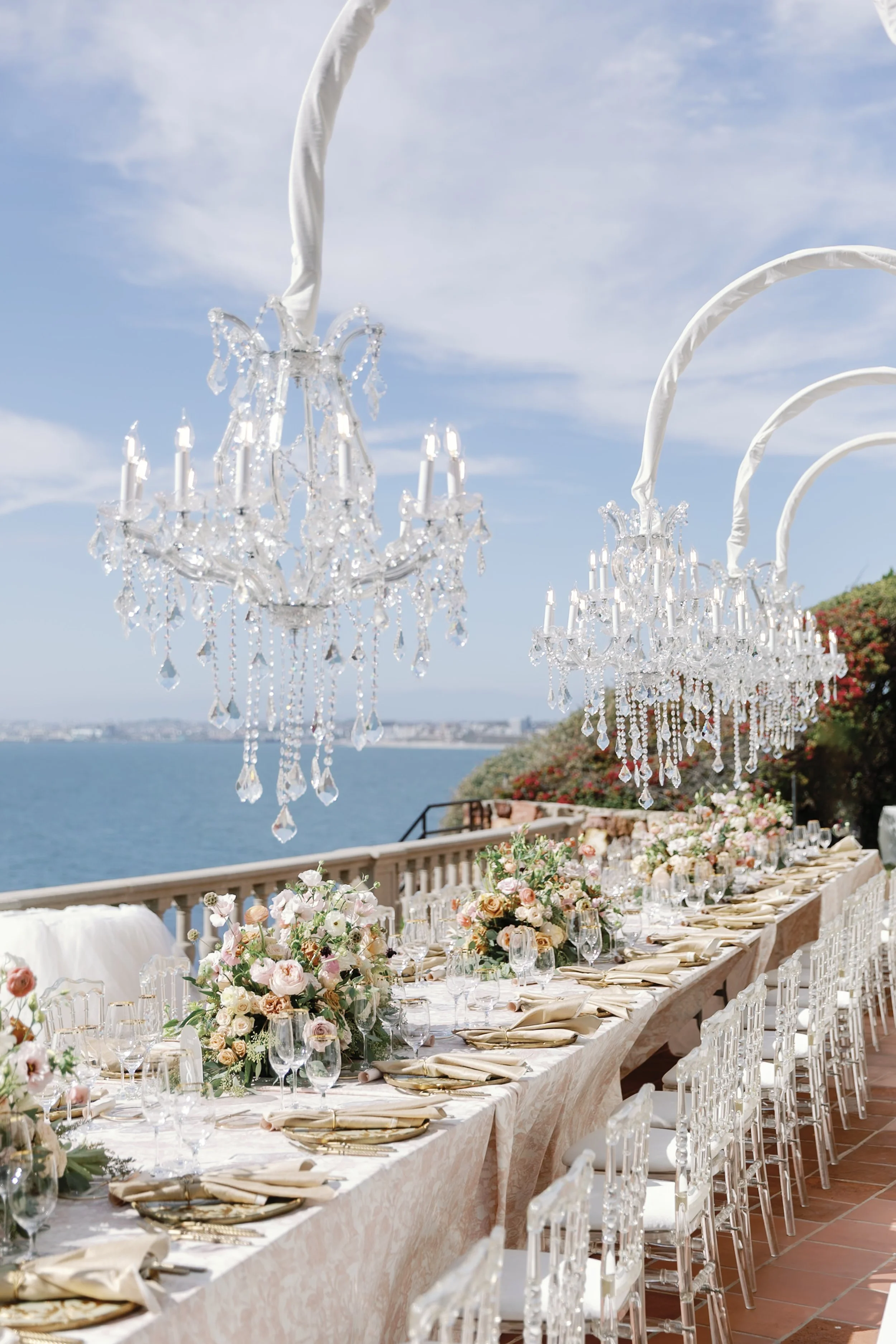Jonathan Davis and Brittany Wedding Tables overlooking the ocean with chandeliers and Birth of Venus inspired decor 