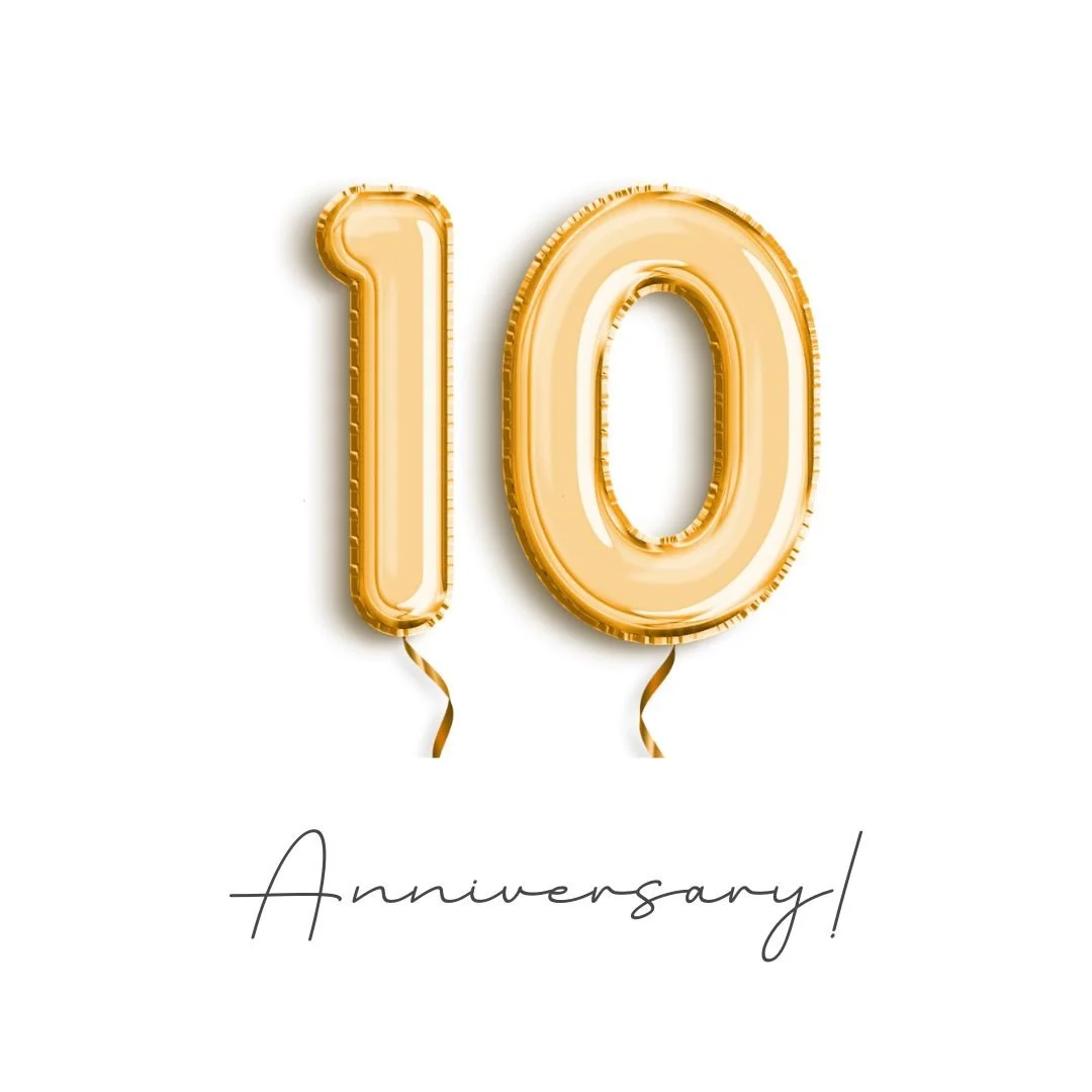 gold foil balloons on white backdrop to celebrate a 10 year anniversary in business as a portrait photographer
