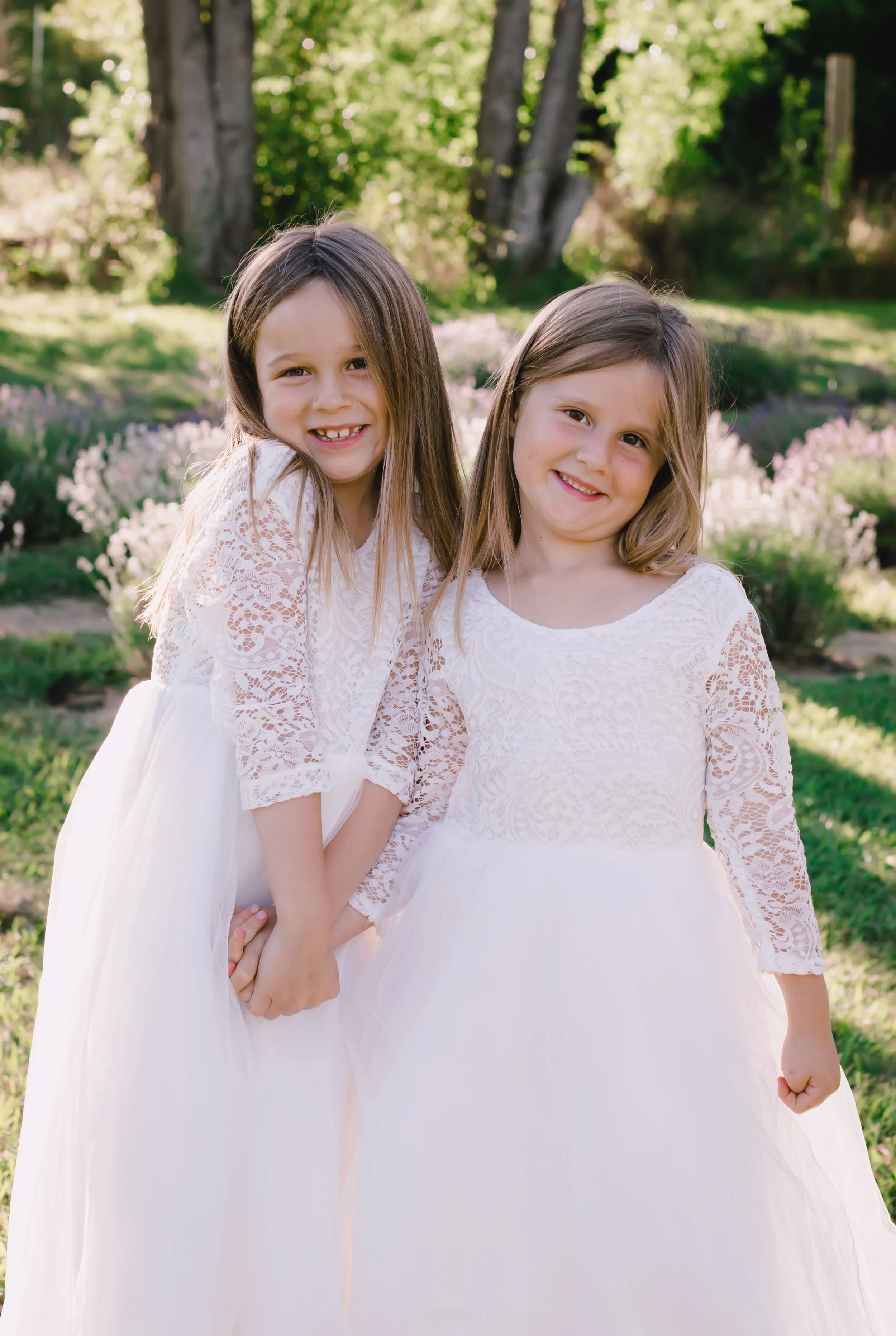 Two sisters posing in the lavender fields at Bywater Hollow Lavender Farm