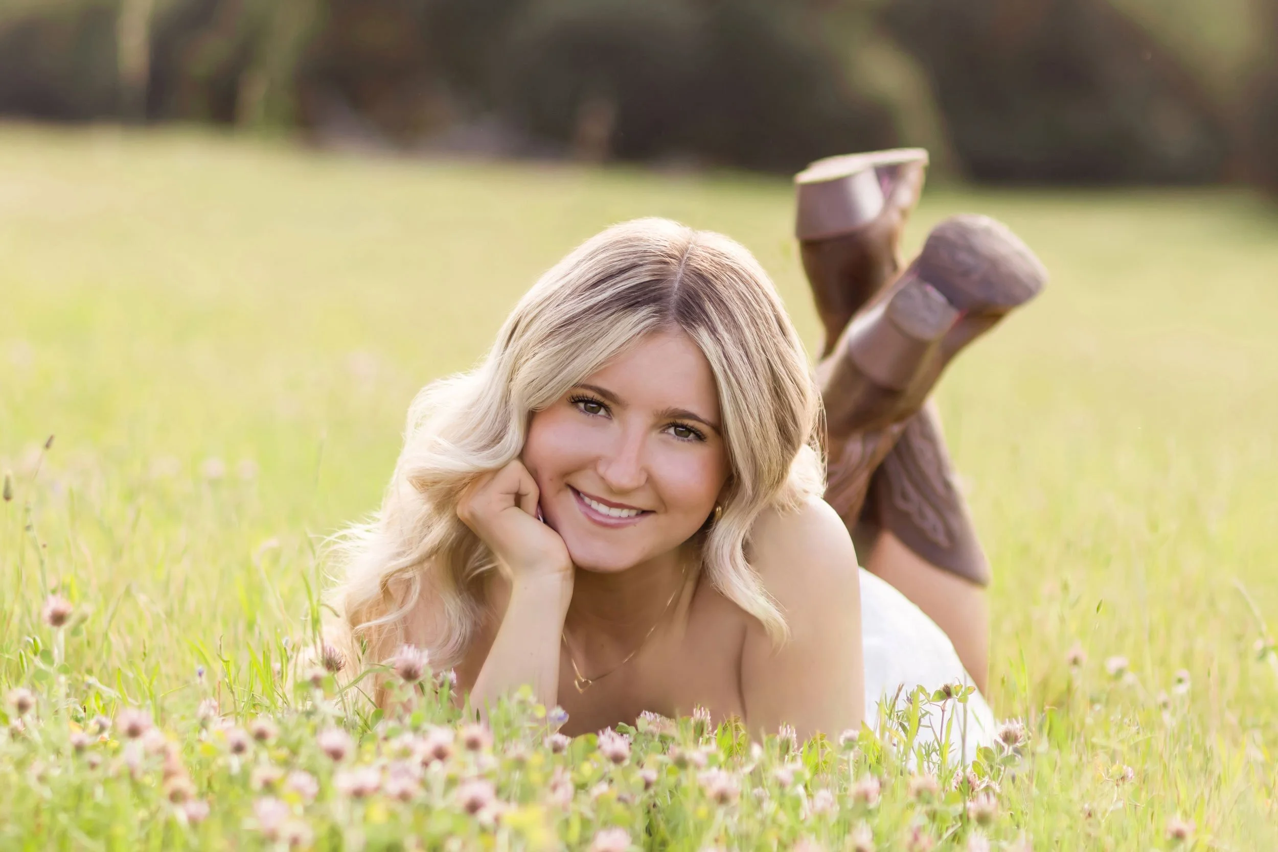 high school senior lays in wildflower field at magnolia ranch trailhead in pilot hill, California