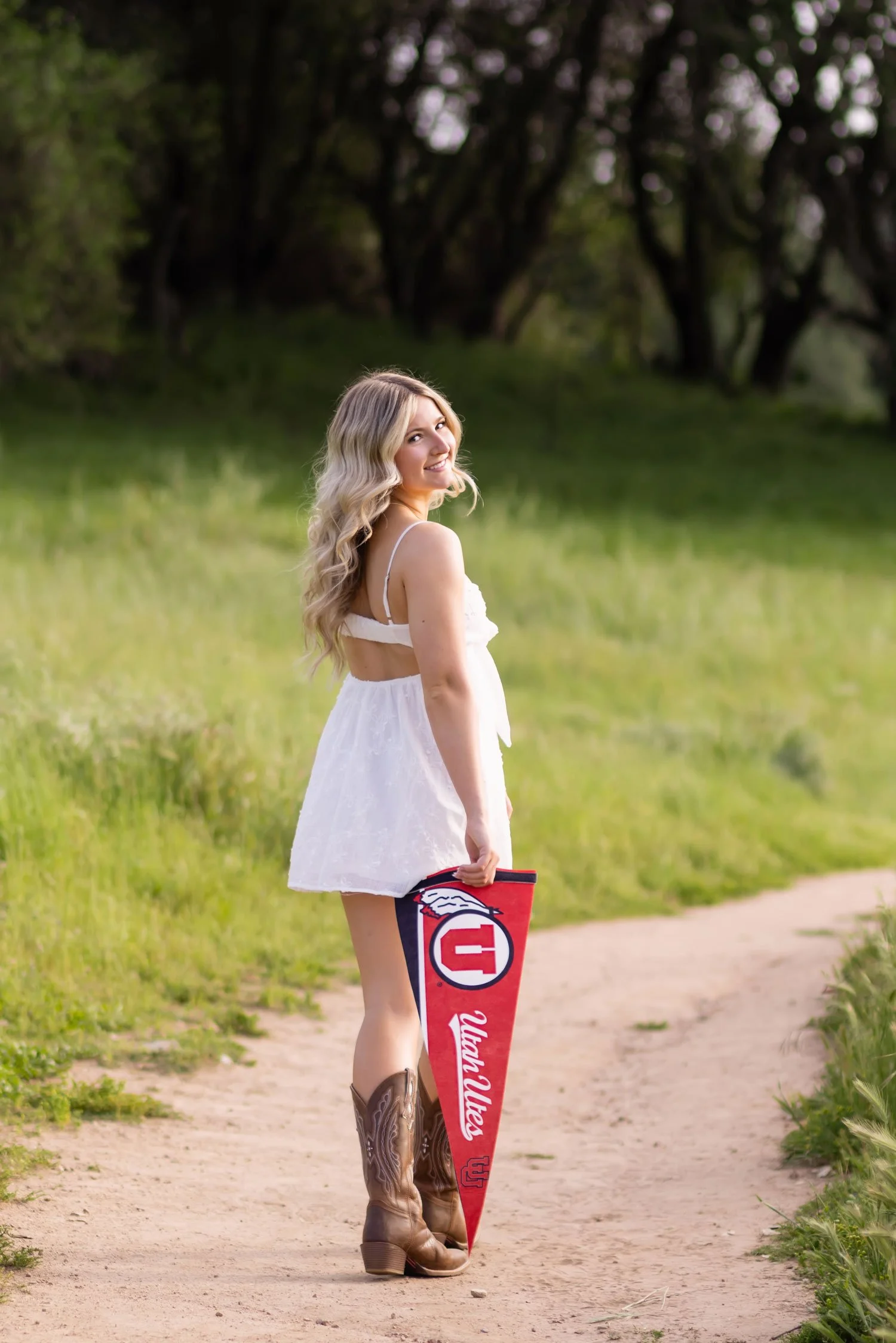high school senior girl holds university of Utah pennant