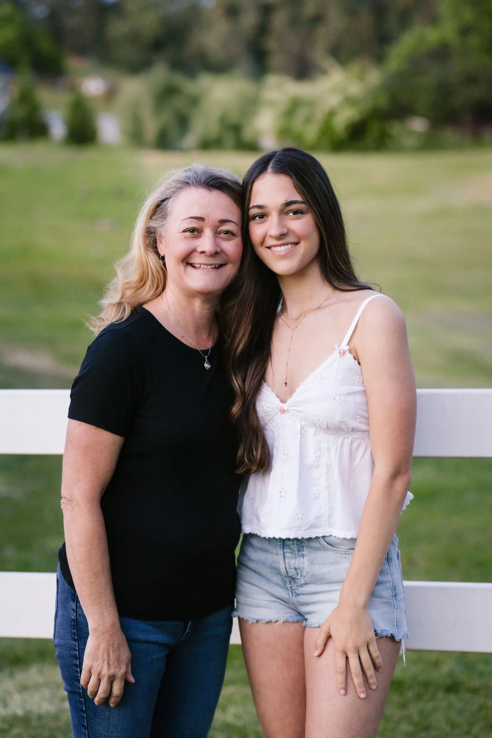 Christian Brothers senior girl wearing a white top poses with her mom at Bywater Hollow Lavender Farm in Lincoln, California