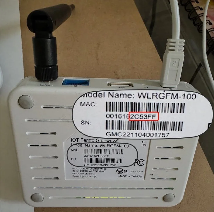 Bottom label of a Gemtek Browan WLRGFM-100 gateway showing model WLRGFM-100 and a MAC address ending in 2C:53:FF, with the final six characters highlighted.
