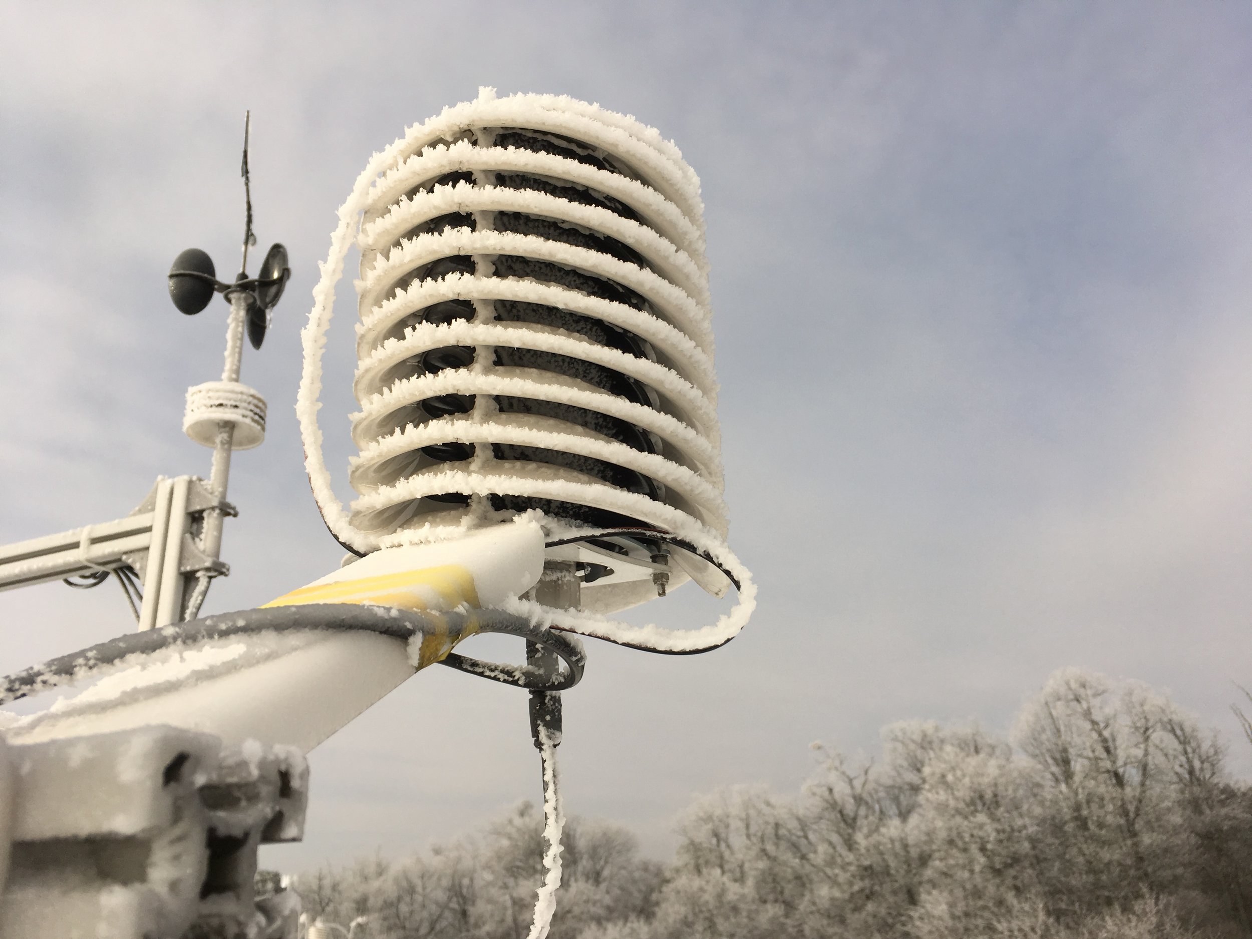 Morning icing covering a BARANI DESIGN weather station in winter