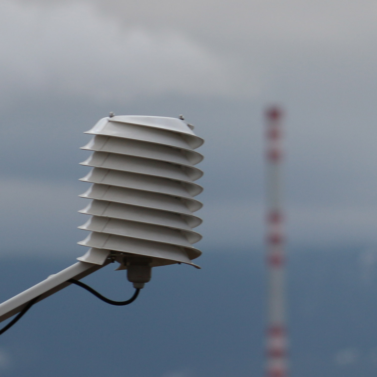 Radiation shield with industrial chimney in background