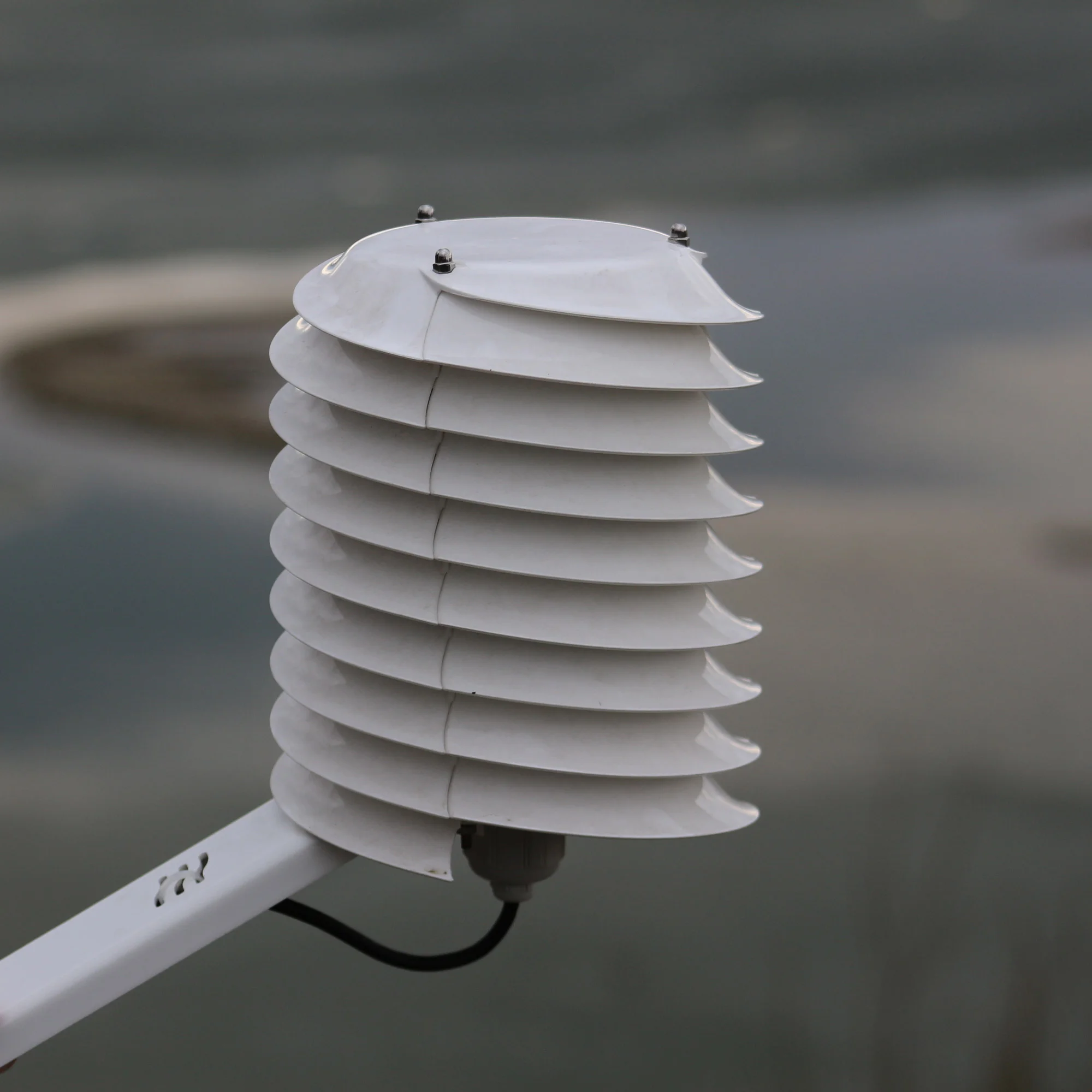 Details of a helical solar radiation shield with a river background