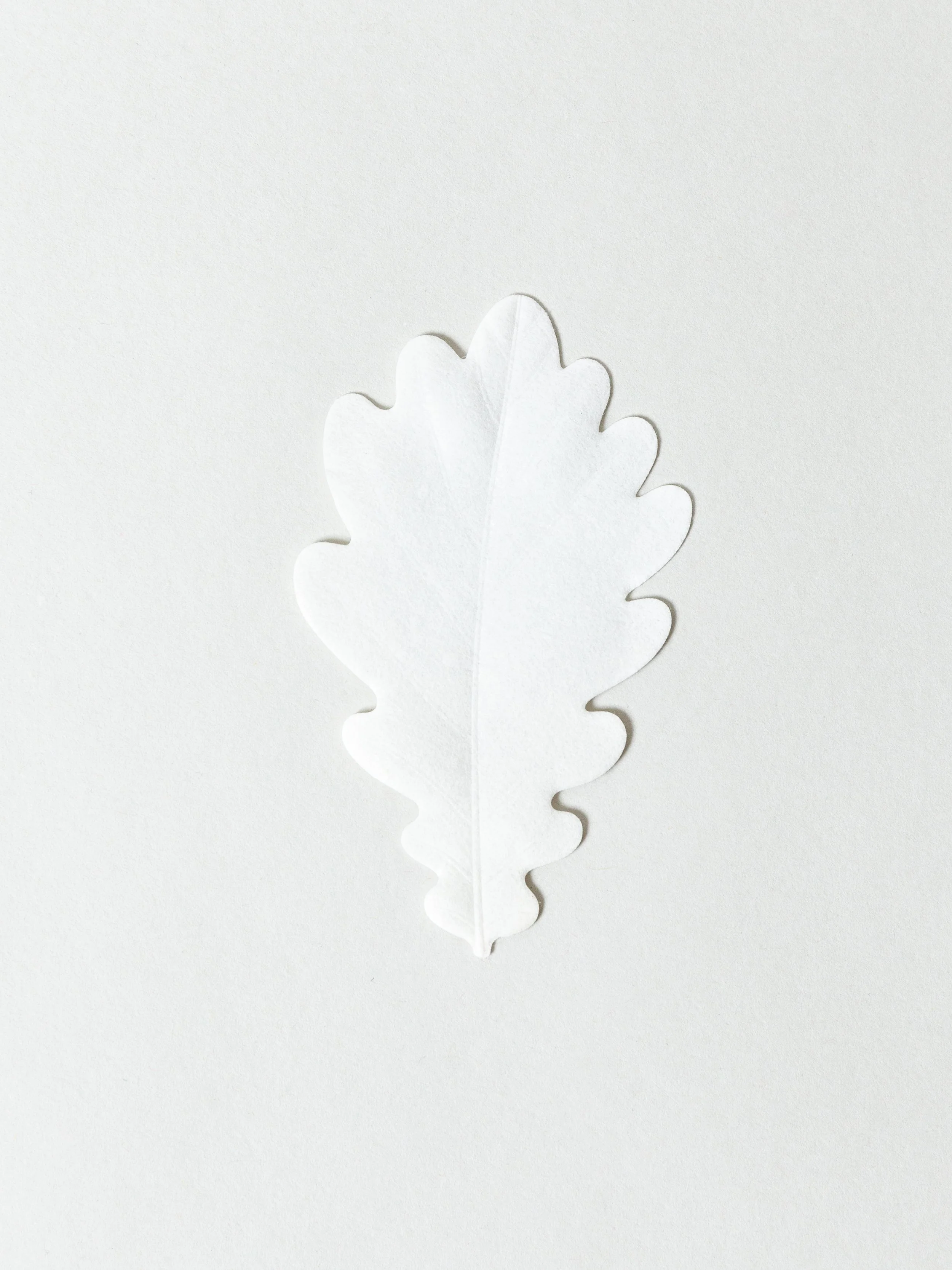 Paper incense in the shape of a white leaf.