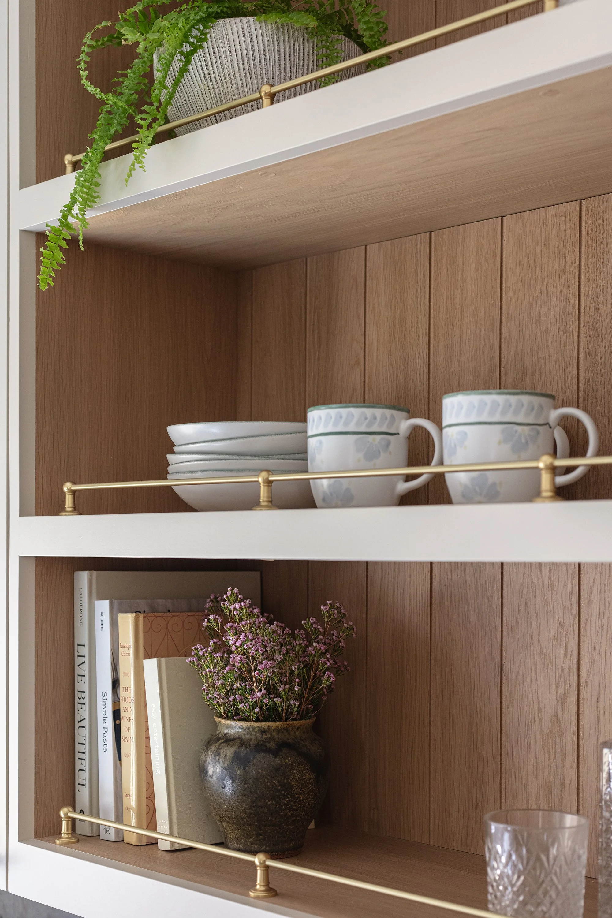 brass hardware, gallery rail, cream cabinets, vintage lighting, taj mahal stone, aged brass light fixtures, aged brass, vintage kitchen, kitchen renovation, white oak wainscot, ivory cabinets