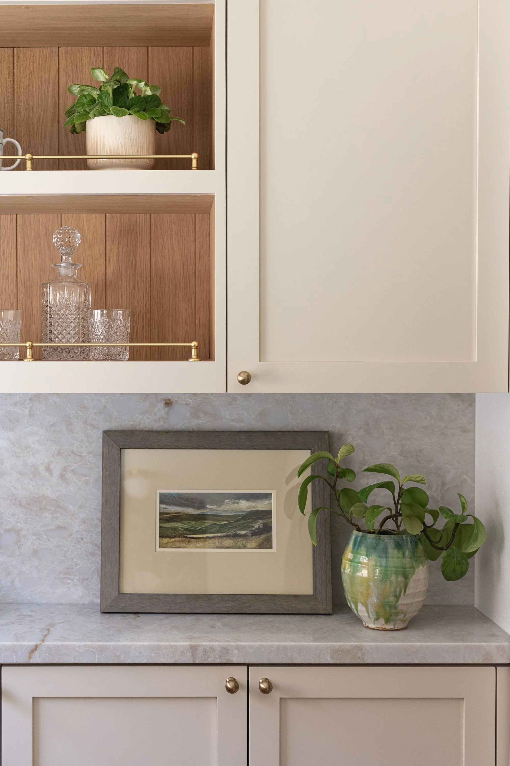 brass hardware, gallery rail, cream cabinets, vintage lighting, taj mahal stone, aged brass light fixtures, aged brass, vintage kitchen, kitchen renovation, white oak wainscot, ivory cabinets
