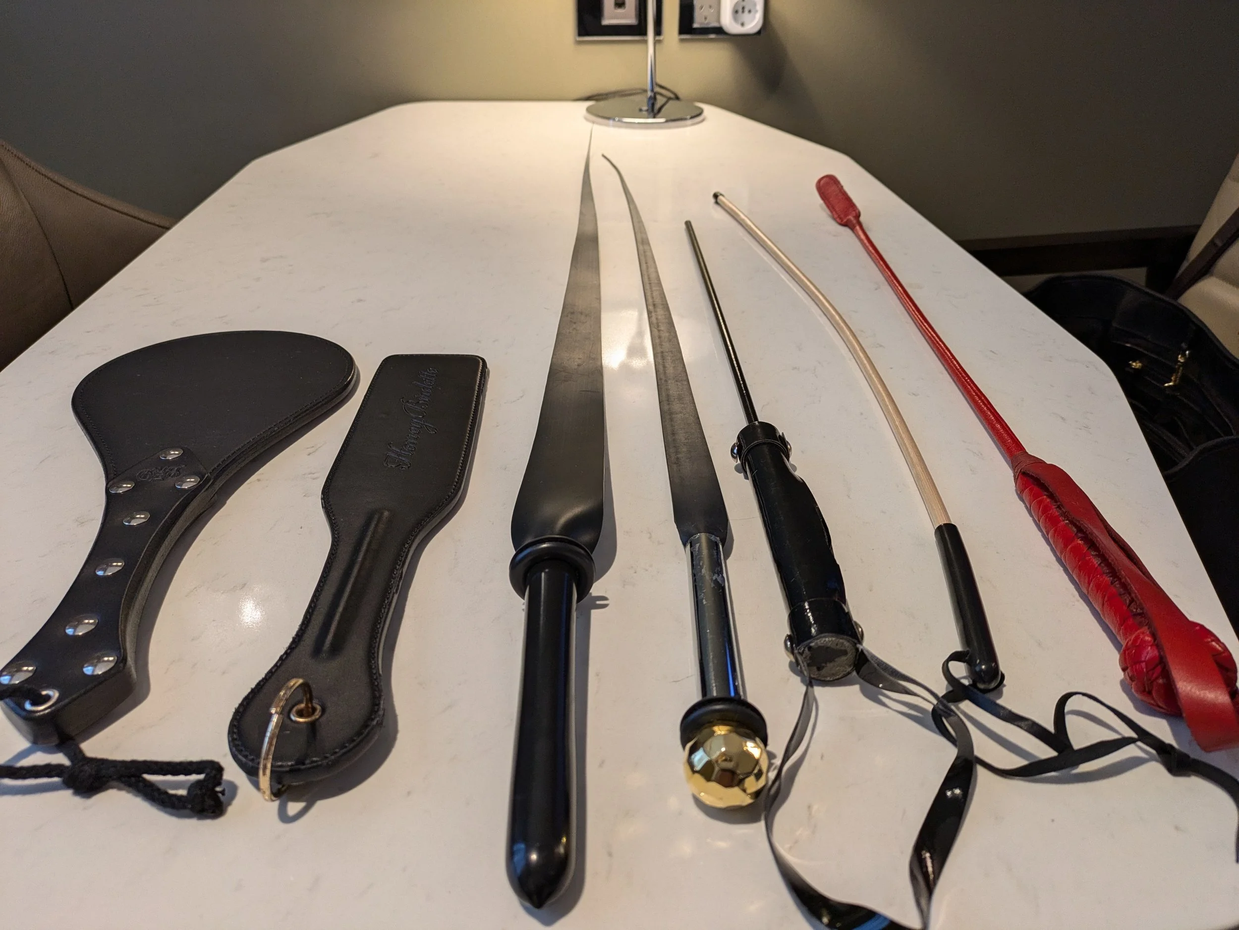 Dominatrix Nina Nyx Leather paddles, flogger