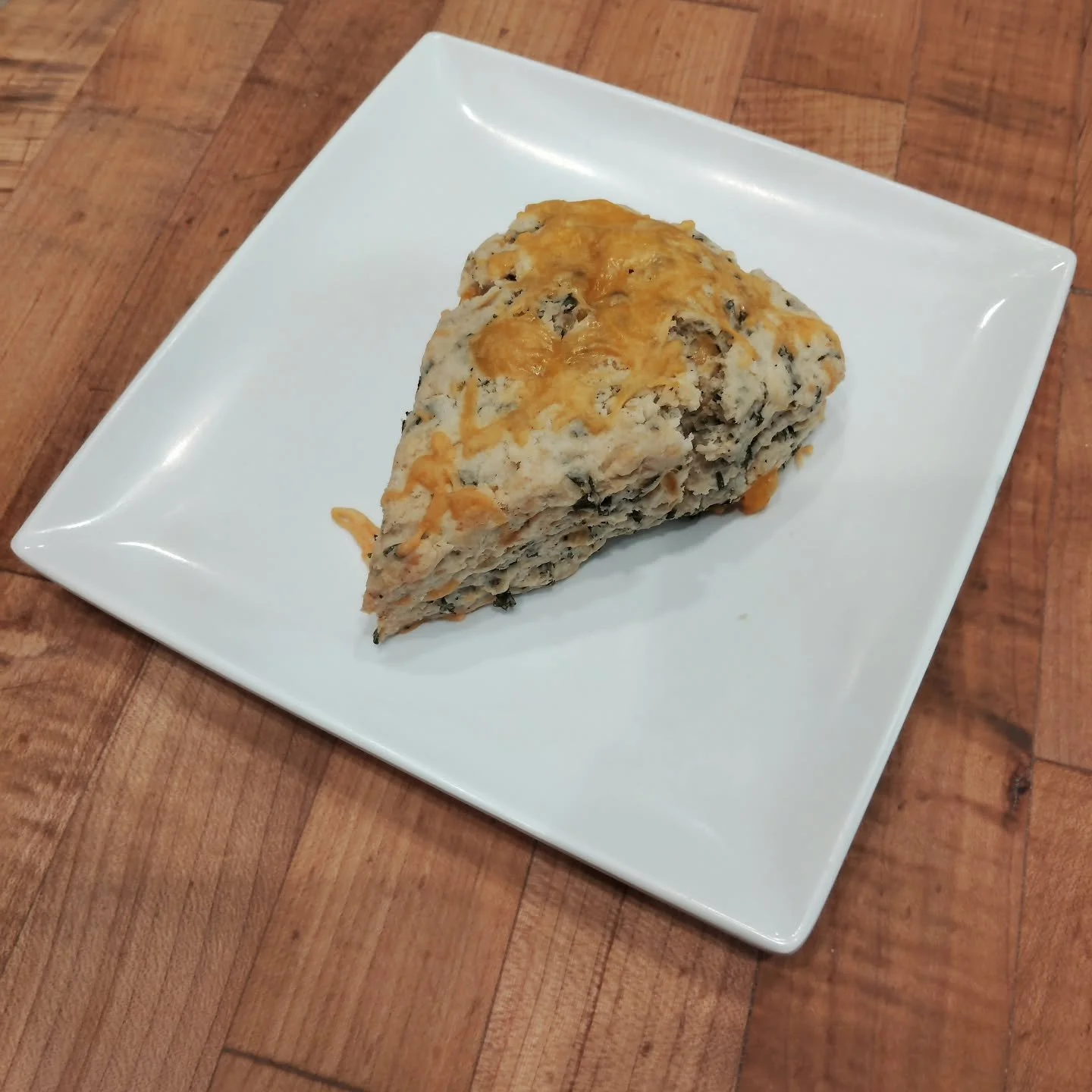 Introducing... The Cheddar Chive Scone!

A savory, creamy, colorful addition to our rotating scone flavors. This one is for those of y'all that have a savory tooth, like Baker Kris. Debuting tomorrow! And we'll have it all week. Stop on by and give i