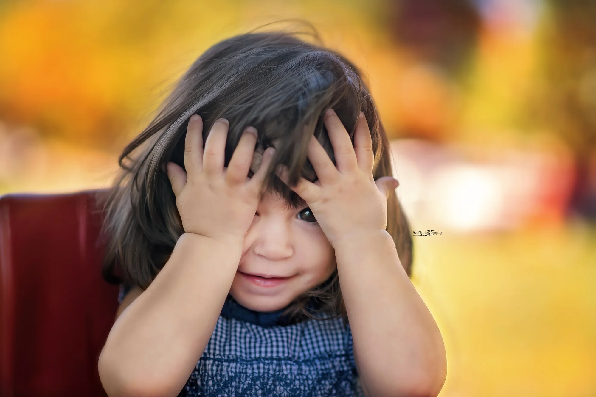 Image of a baby girl playing peek-a-boo, taken in Bergen County, New Jersey