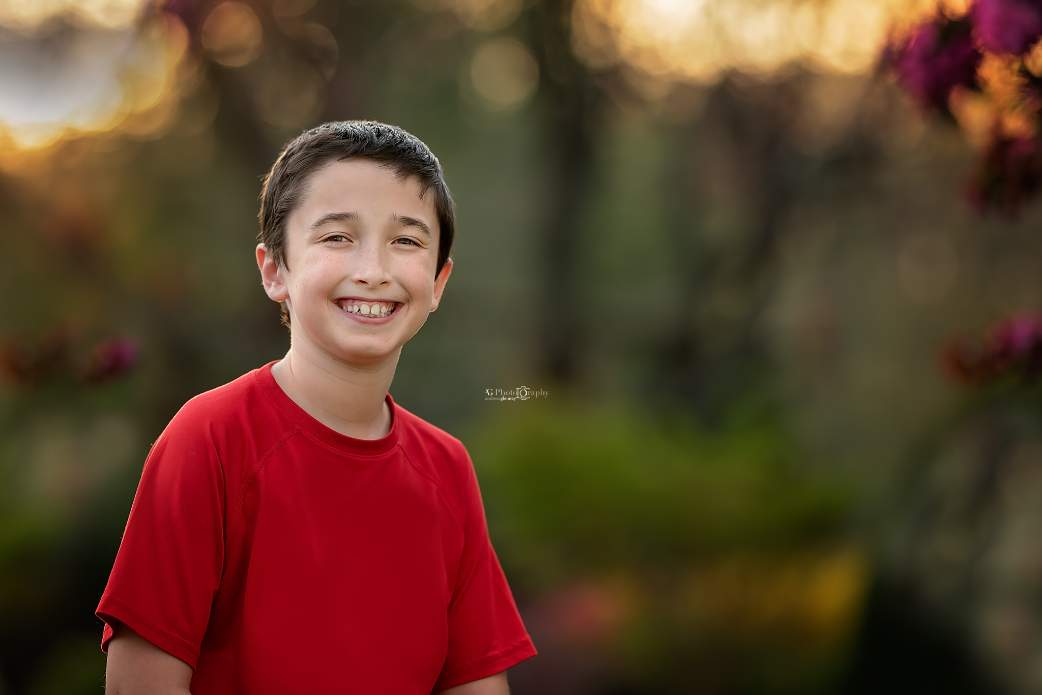 Boy smiling while being photographed during a spring session