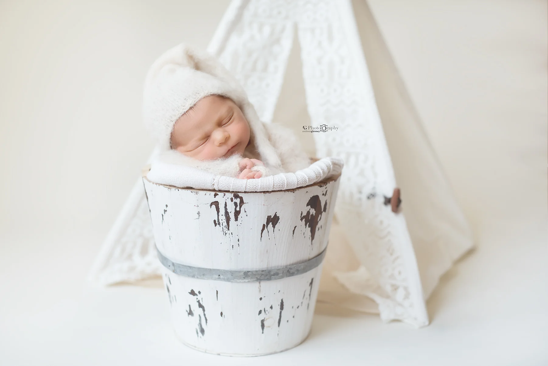 Newborn posed in a bucket during a photo session in Bergen County, New Jersey