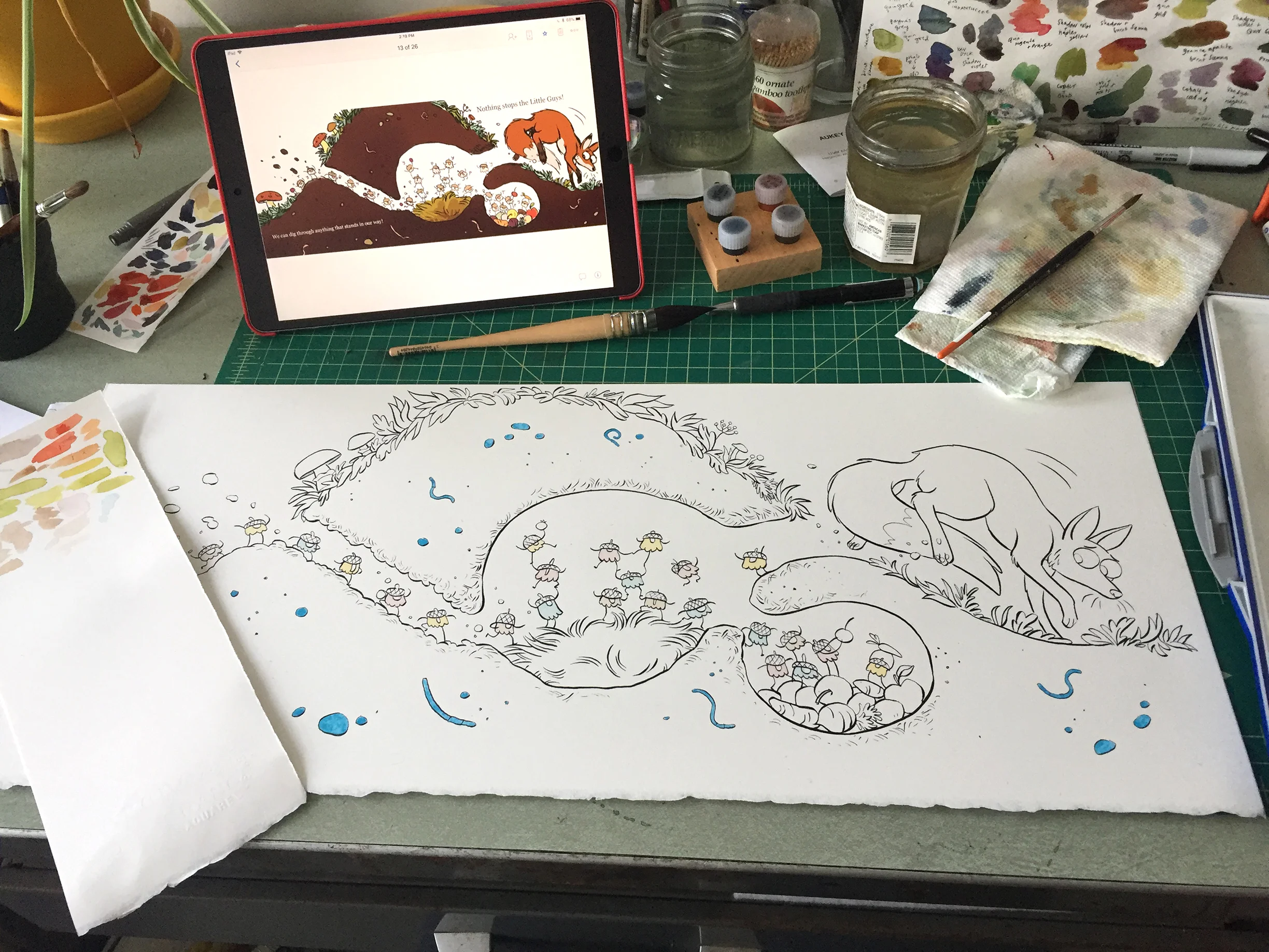 Time to paint! Do you see those blue areas? That is masked off with one of these Molotow Masking Pens . The paint won’t stick to those areas, preserving white paper underneath. I mask off small detailed areas (like earthworms) so I can do big washes without worrying about having to paint around them. You can also see that I have the digital color sketch up on my ipad in front of me for reference. I want to get close to my digital colors, since I know I like them! I don’t like having to think too much while I’m painting.
