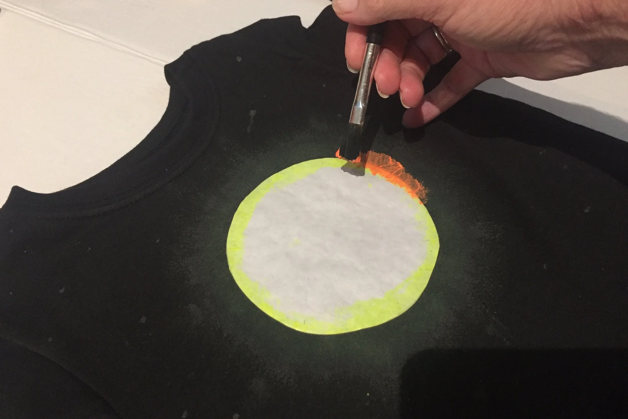 If you look closely, you can see the faint yellow paint layer peeking out around the orange layer.